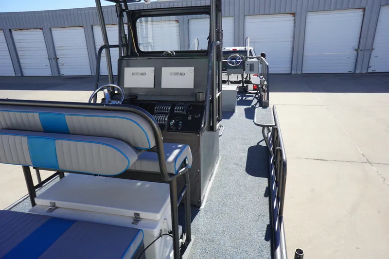 Slide: The Image of 2016 Boat Right 25'8'' Custom Flat boat interior with seating and control panel. - 14