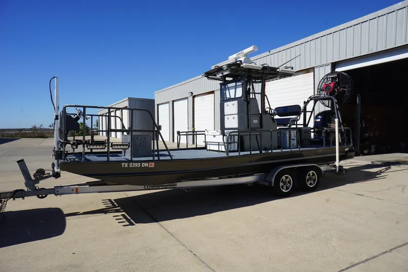 Slide: The Image of 2016 Boat Right 25'8'' Custom Flat boat on trailer outside a warehouse. - 2