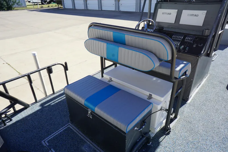 Slide: The Image of 2016 Boat Right 25'8'' Custom Flat interior with blue and gray seating and control panel. - 7