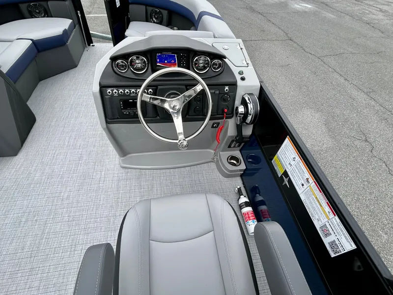 Slide: The Image of 2025 Berkshire 22RFX ARCH CTS 2.75 boat interior with steering console and seating. - 13