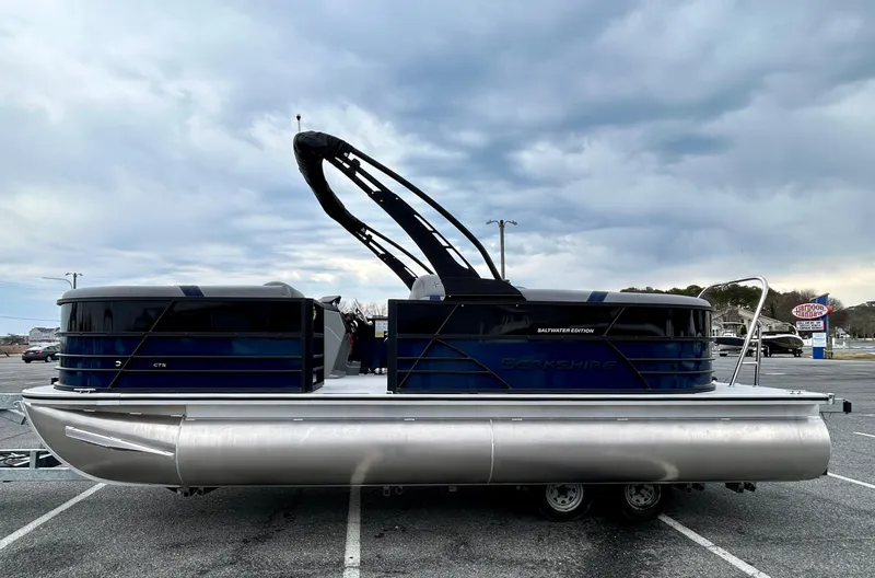 Slide: The Image of 2025 Berkshire 22RFX ARCH CTS 2.75 pontoon boat in parking lot, side view. - 2