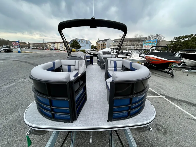 Slide: The Image of 2025 Berkshire 22RFX ARCH CTS 2.75 pontoon boat with spacious seating, docked outdoors. - 3