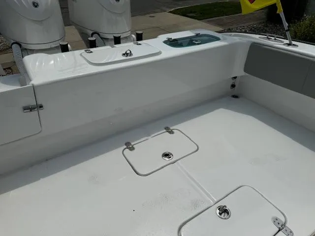 Slide: The Image of 2025 Cape Horn 31T boat deck with storage compartments and outboard motors. - 14