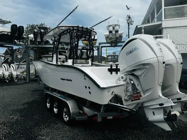 Slide: The Image of 2025 Cape Horn 31T boat with Yamaha engines on a trailer in a marina. - 3