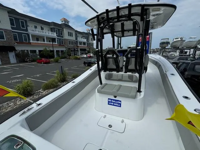 Slide: The Image of 2025 Cape Horn 31T boat with seating and 60-gallon live well, docked near buildings. - 10