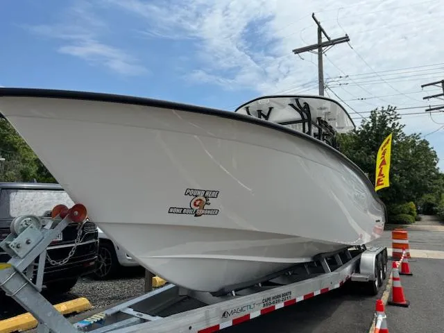 Slide: The Image of 2025 Cape Horn 31T boat on trailer, displayed outdoors with traffic cones. - 12