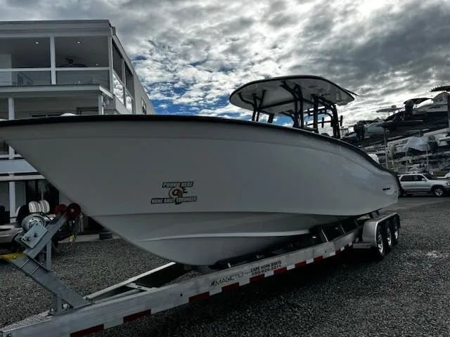 Slide: The Image of 2025 Cape Horn 31T boat on trailer, parked outdoors under cloudy sky. - 7
