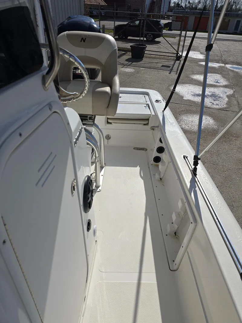 Slide: The Image of 2016 NauticStar 227 XTS boat interior with steering wheel and seating. - 10