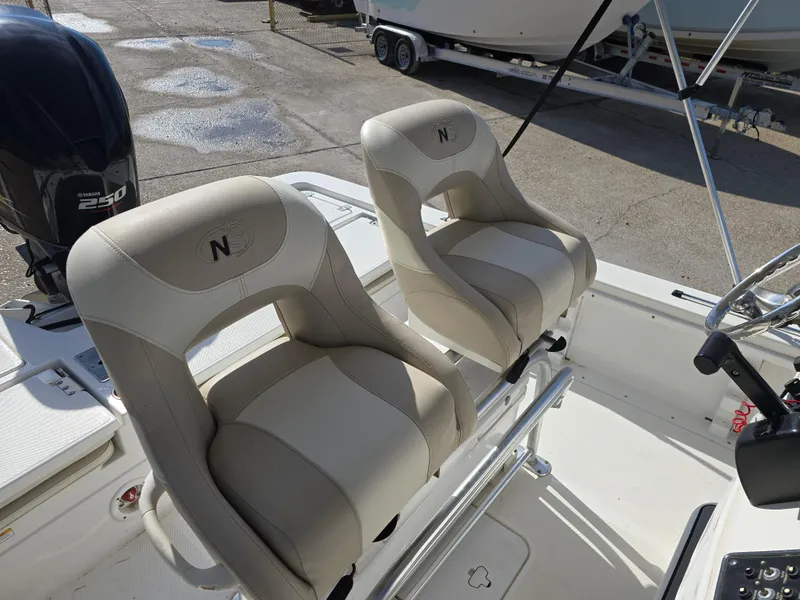 Slide: The Image of 2016 NauticStar 227 XTS boat seats with steering console and motor in view. - 12