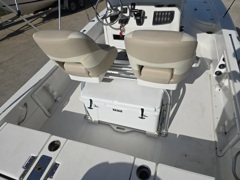 Slide: The Image of 2016 NauticStar 227 XTS boat interior with dual seats and cooler. - 13