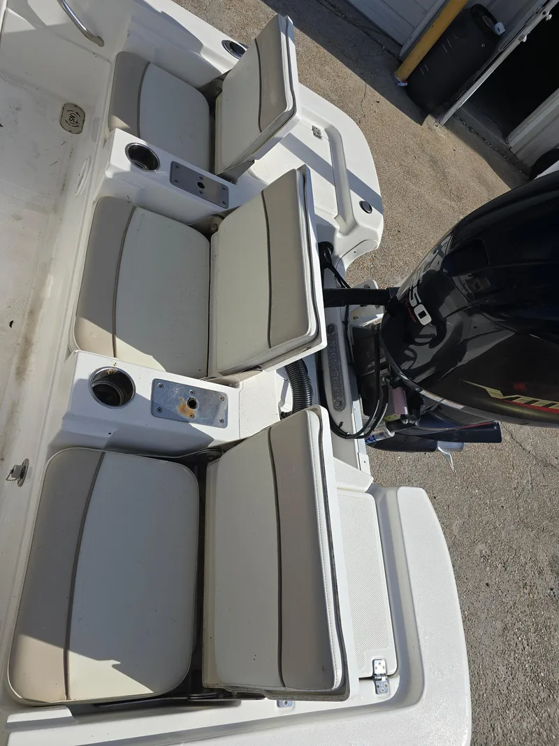 Slide: The Image of 2016 NauticStar 227 XTS boat seats and engine, showcasing comfortable seating and powerful motor. - 14