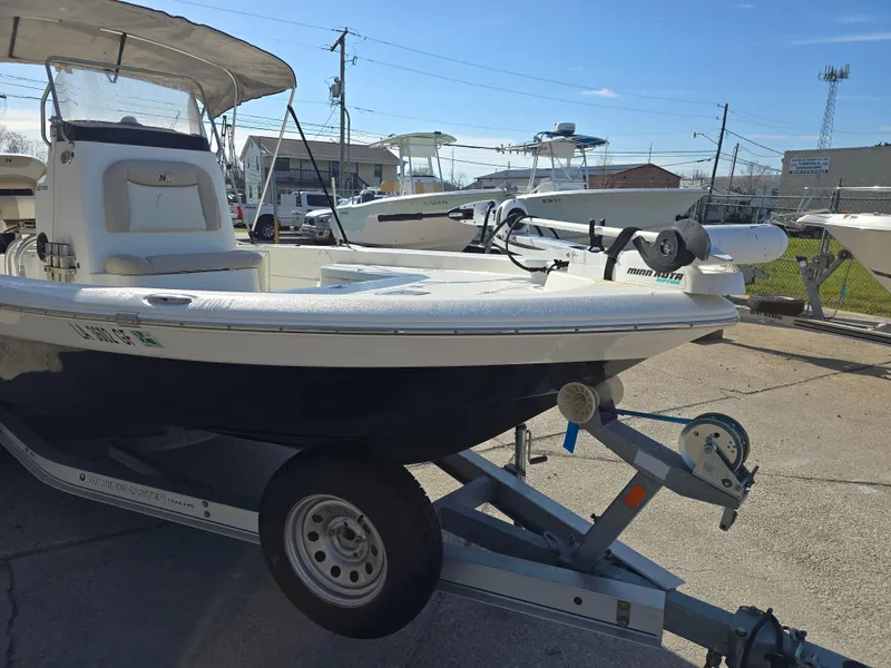 Slide: The Image of 2016 NauticStar 227 XTS boat on trailer in sunny marina setting. - 4