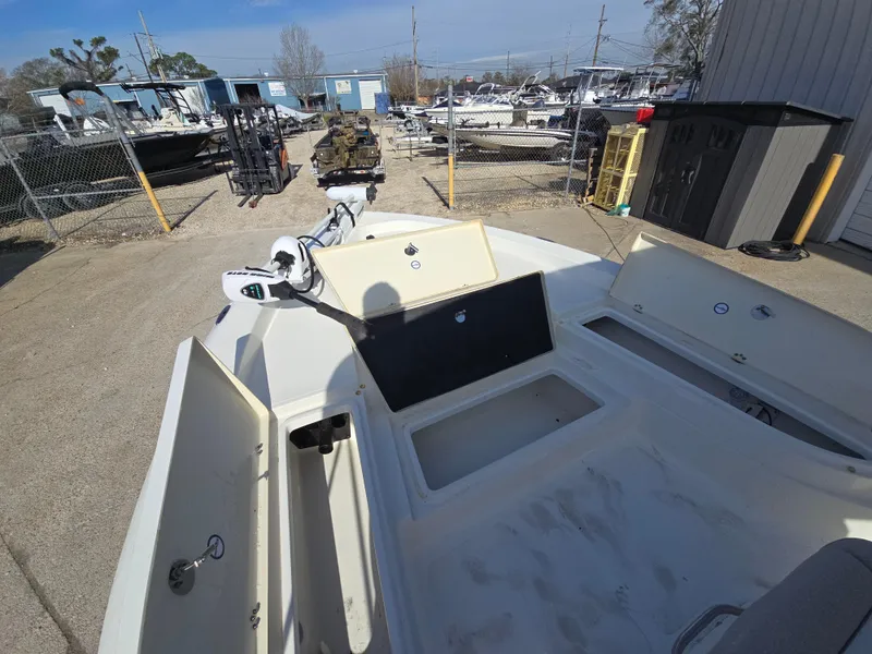 Slide: The Image of 2016 NauticStar 227 XTS boat in a storage yard, showcasing open compartments. - 7