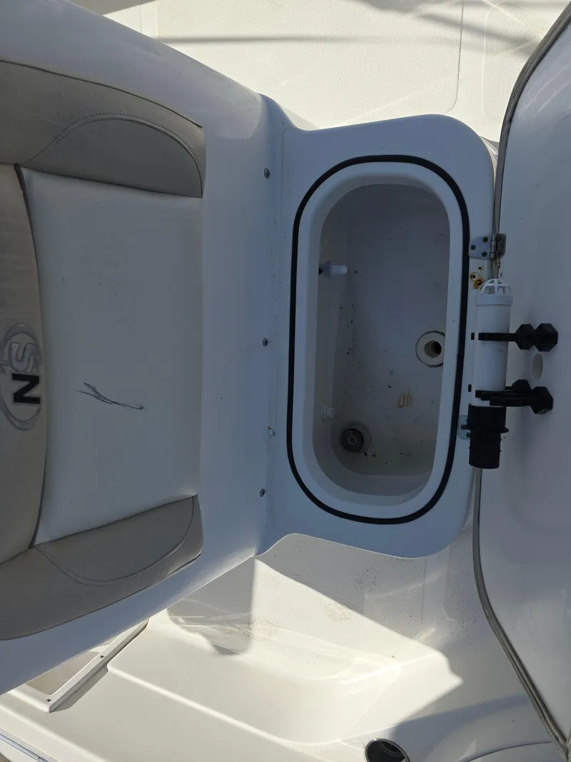Slide: The Image of 2016 NauticStar 227 XTS boat interior with open storage compartment. - 8