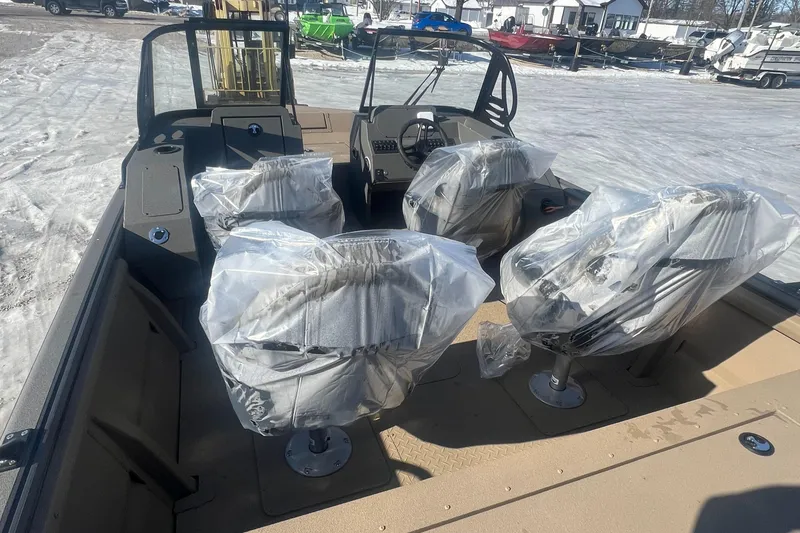 Slide: The Image of 2025 SeaArk Protege 200 boat with Suzuki outboard motor on gravel lot. - 3