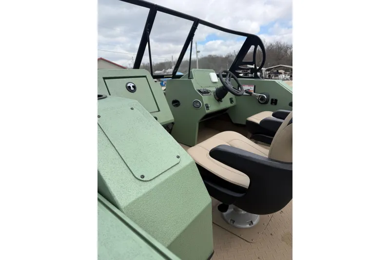 Slide: The Image of Interior of 2025 SeaArk Protege 200 boat with steering wheel and seating. - 7