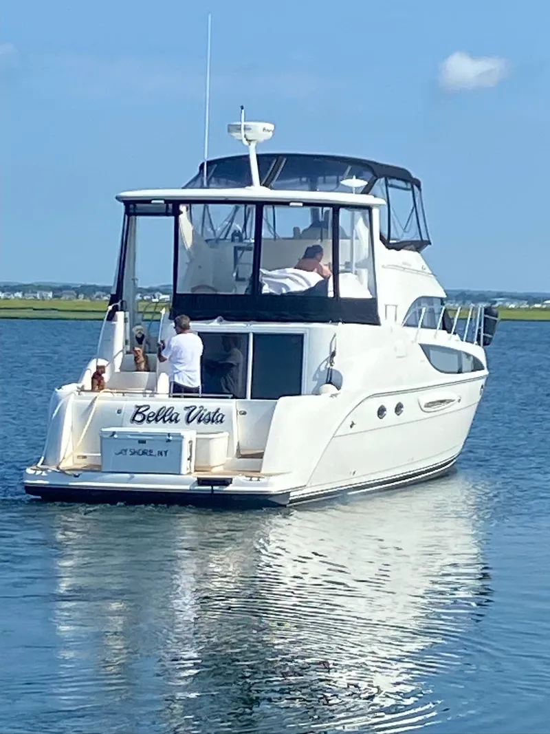 Slide: The Image of 2005 Meridian 459 Motoryacht on calm water, rear view, clear sky. - 2