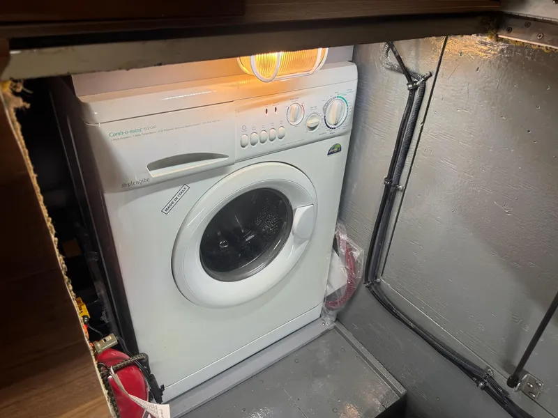 Slide: The Image of Washing machine inside a 2005 Meridian 459 Motoryacht compartment, illuminated by overhead light. - 25