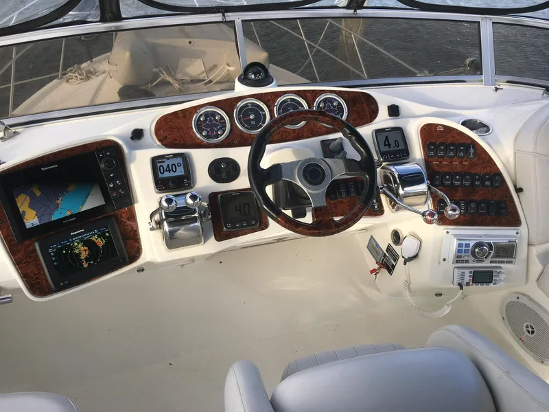 Slide: The Image of 2005 Meridian 459 Motoryacht helm with navigation instruments and controls, featuring wood accents. - 3