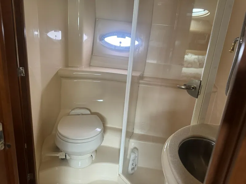 Slide: The Image of Bathroom interior of 2005 Meridian 459 Motoryacht with toilet, sink, and porthole window. - 8