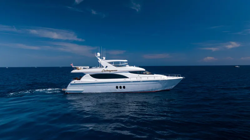 Slide: The Image of 2005 Hatteras 80 Motor Yacht cruising on open sea under clear blue sky. - 1