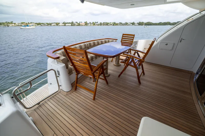 Slide: The Image of Outdoor deck of 2005 Hatteras 80 Motor Yacht with wooden furniture and ocean view. - 11