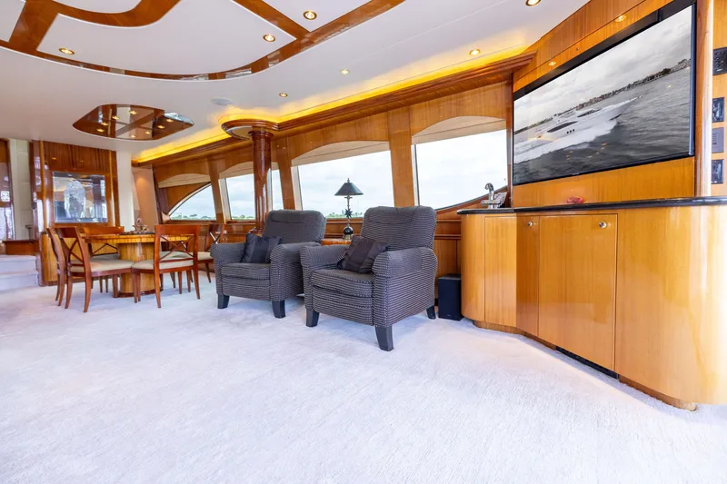 Slide: The Image of Luxurious interior of 2005 Hatteras 80 Motor Yacht with elegant seating and wood finishes. - 15