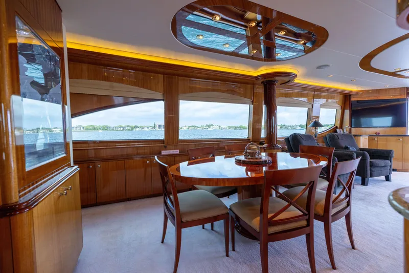 Slide: The Image of Luxurious interior of 2005 Hatteras 80 Motor Yacht with elegant dining area and panoramic windows. - 17