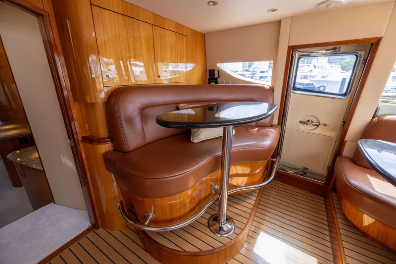 Slide: The Image of Luxurious interior of 2005 Hatteras 80 Motor Yacht with elegant seating and wooden finishes. - 25