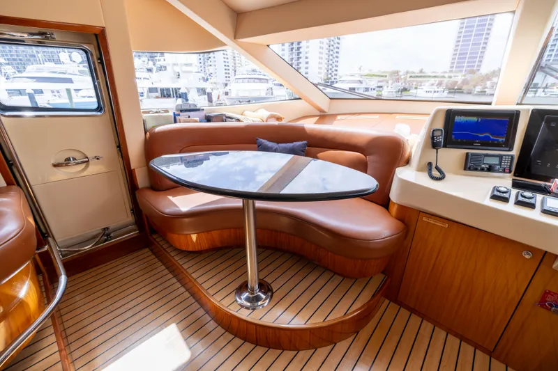 Slide: The Image of 2005 Hatteras 80 Motor Yacht interior with leather seating and navigation equipment. - 26