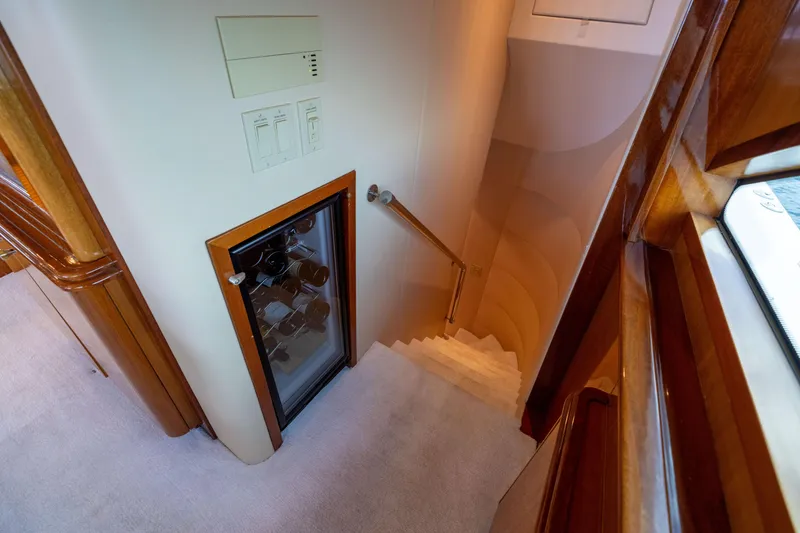 Slide: The Image of Staircase in 2005 Hatteras 80 Motor Yacht with wooden accents and wine cooler. - 29