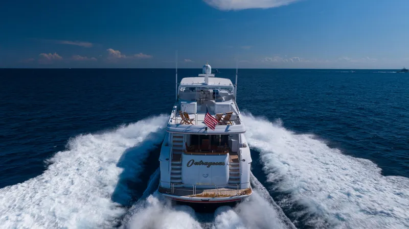 Slide: The Image of 2005 Hatteras 80 Motor Yacht cruising on open sea under clear blue sky. - 4