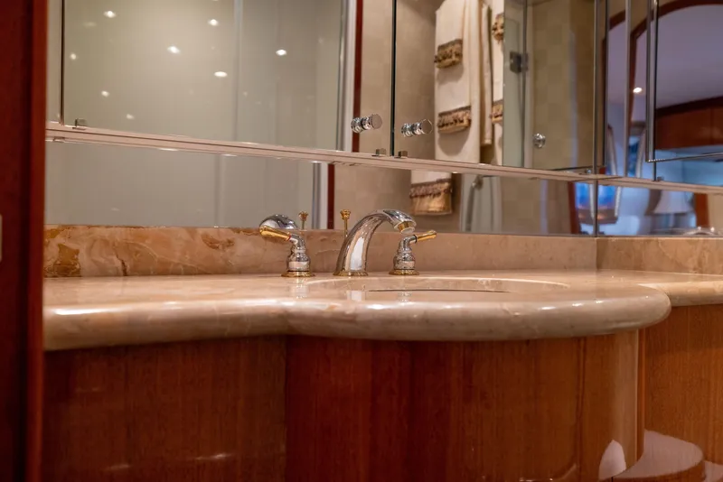 Slide: The Image of Luxurious bathroom vanity on 2005 Hatteras 80 Motor Yacht with marble countertop and elegant fixtures. - 44