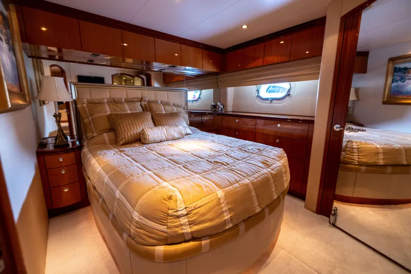 Slide: The Image of Luxurious bedroom interior of 2005 Hatteras 80 Motor Yacht with elegant wood finishes. - 47