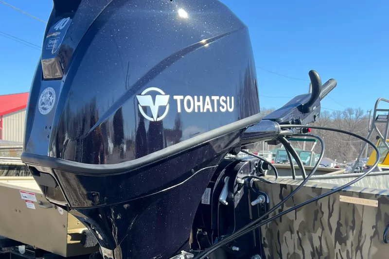 The Image of Tohatsu outboard motor on 2025 SeaArk 1652 MVJT boat, outdoor setting. - 0