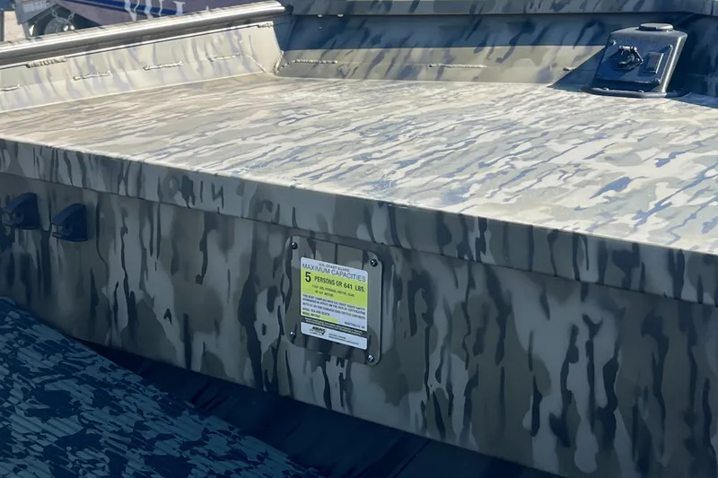 Slide: The Image of 2025 SeaArk 1652 MVJT boat with camouflage design and control panel. - 4