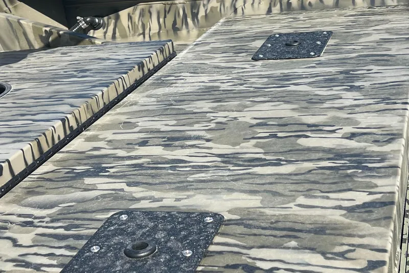 Slide: The Image of 2025 SeaArk 1652 MVJT boat with Tohatsu motor on trailer, in water spray background. - 7