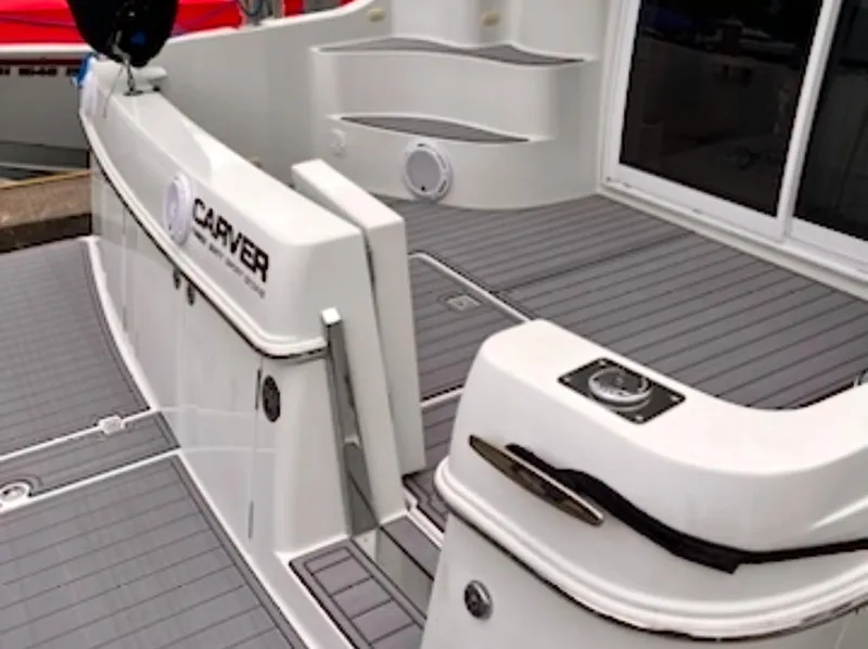 Slide: The Image of 2004 Carver 360 Sport Sedan boat deck with sleek white design and modern features. - 24