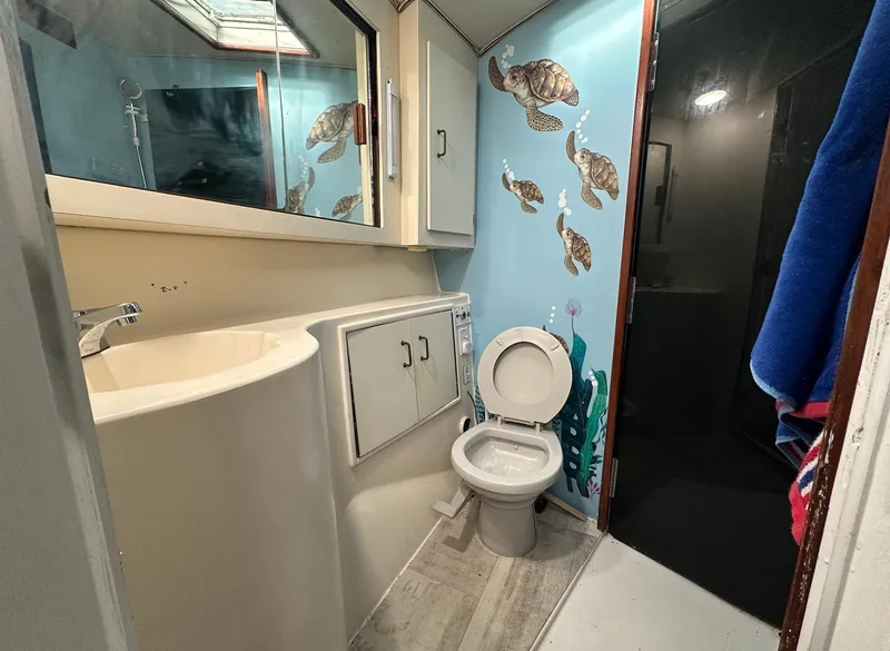 Slide: The Image of Bathroom in 1987 Ocean Yachts 48 Super Sport with marine-themed decor and modern fixtures. - 10
