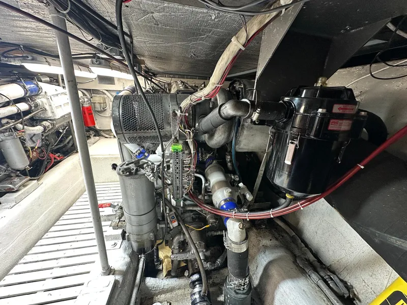 Slide: The Image of Engine room of 1987 Ocean Yachts 48 Super Sport, showcasing mechanical components and wiring. - 13