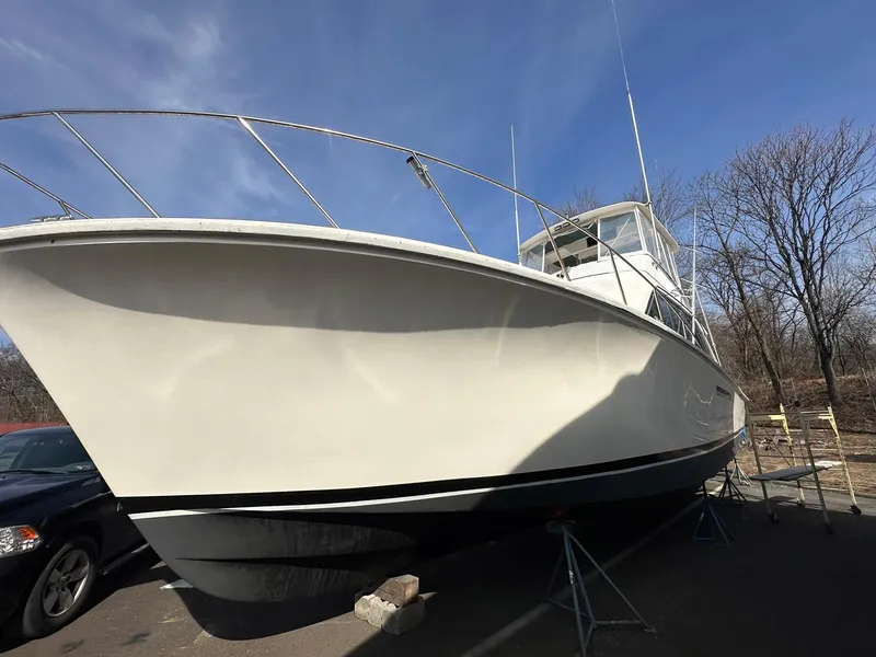 Slide: The Image of 1987 Ocean Yachts 48 Super Sport boat on stands, clear sky background. - 18