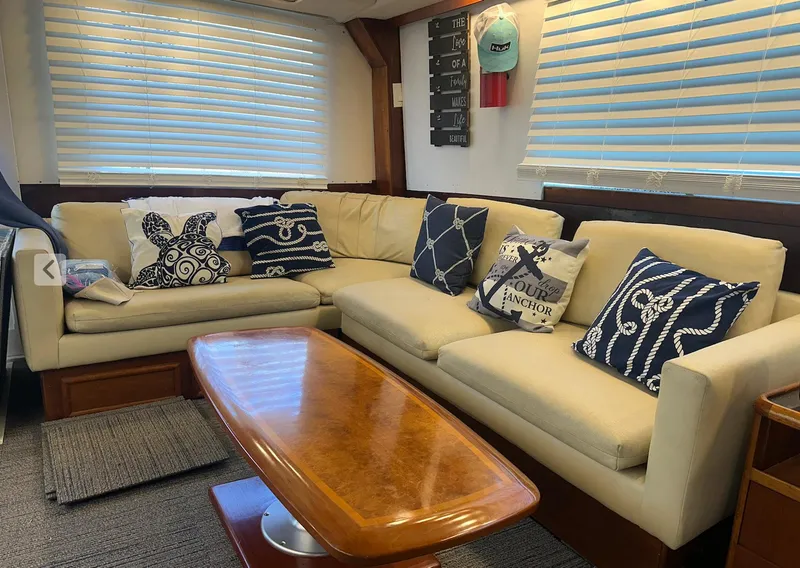 Slide: The Image of Luxurious 1987 Ocean Yachts 48 Super Sport interior with beige sofa and nautical-themed cushions. - 3