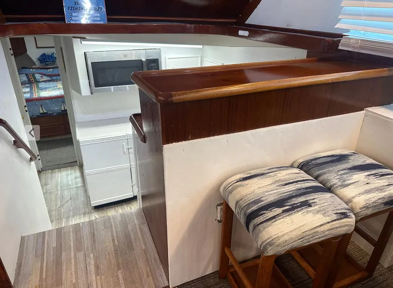 Slide: The Image of 1987 Ocean Yachts 48 Super Sport interior with kitchen and seating area. - 4