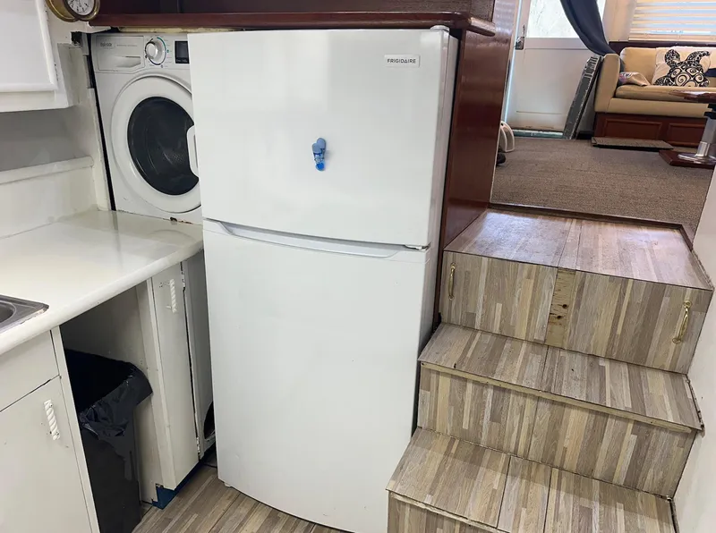 Slide: The Image of Laundry and kitchen area inside 1987 Ocean Yachts 48 Super Sport boat. - 5