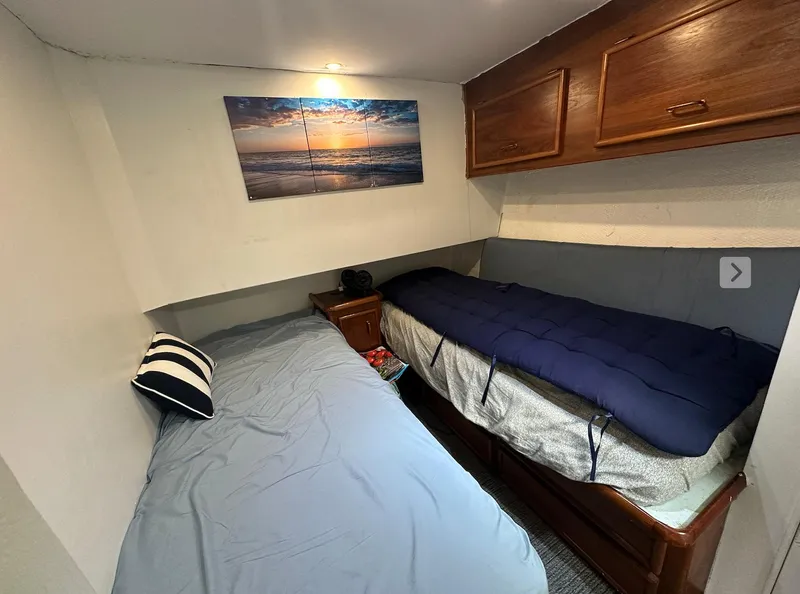 Slide: The Image of Interior cabin of 1987 Ocean Yachts 48 Super Sport with twin beds and nautical decor. - 7