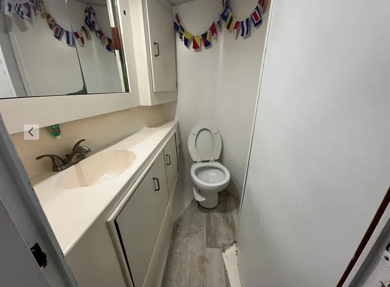 Slide: The Image of Bathroom interior of 1987 Ocean Yachts 48 Super Sport, featuring sink and toilet. - 8