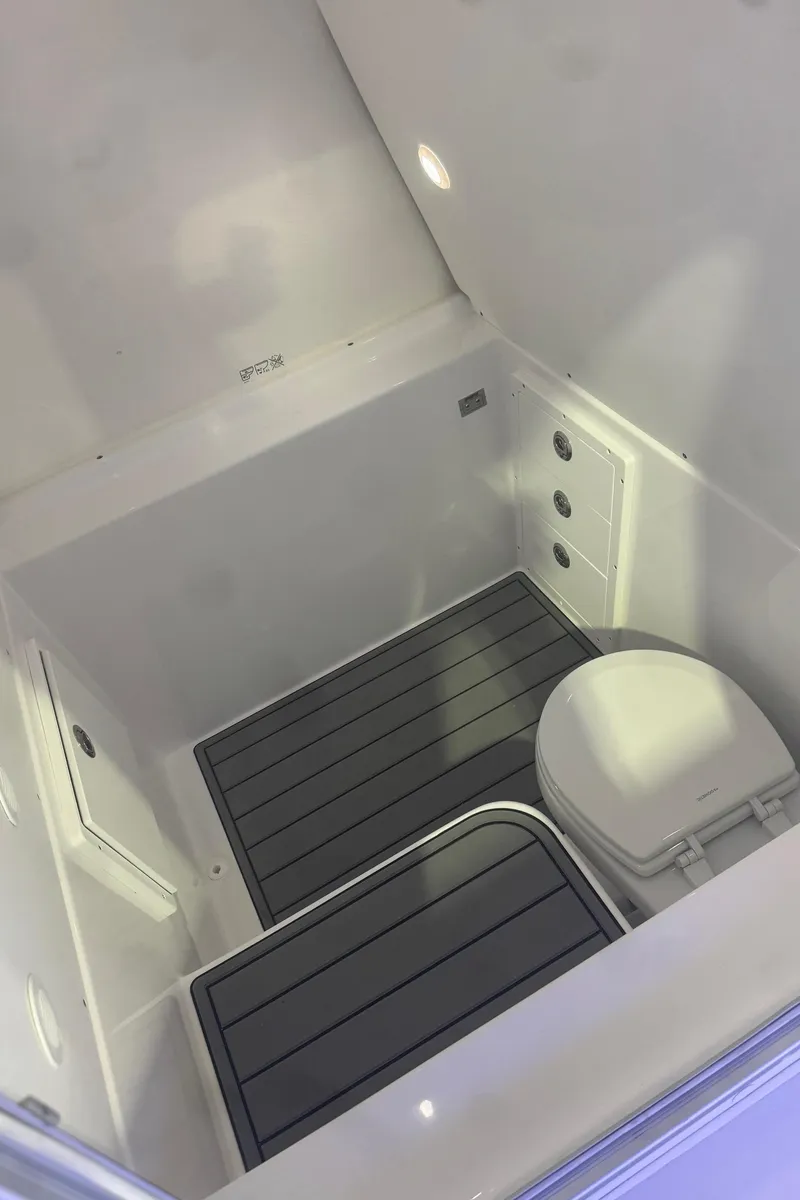 Slide: The Image of 2025 Cape Horn 36 XS boat interior with compact marine toilet and non-slip flooring. - 18