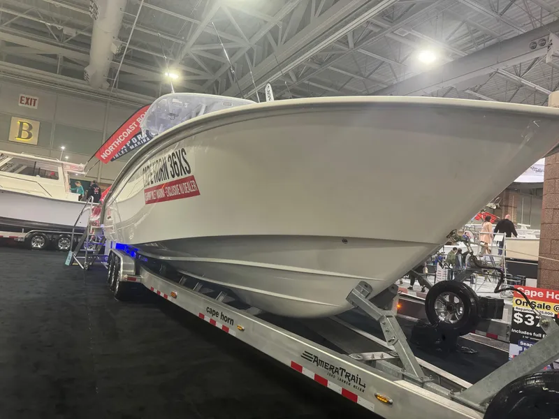 Slide: The Image of 2025 Cape Horn 36 XS boat displayed on trailer at indoor exhibition. - 20