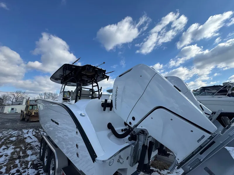 Slide: The Image of 2025 Cape Horn 36 XS boat with dual engines, parked on snowy ground under a cloudy sky. - 9