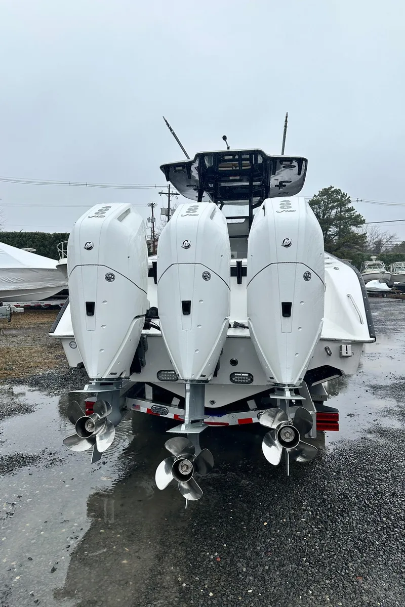 Slide: The Image of 2025 Cape Horn 36 XS boat on trailer, parked outdoors on gravel. - 2